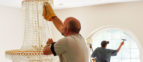 Cleaning chandeliers and high windows. Photo/source: Window Care, Inc.
